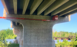 Reach-All extends under bridge for inspection. MDOT Big Bridge Scoping.