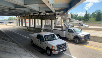 MDOT Big Bridge Scoping. Bucket trucks used under bridge for inspection.